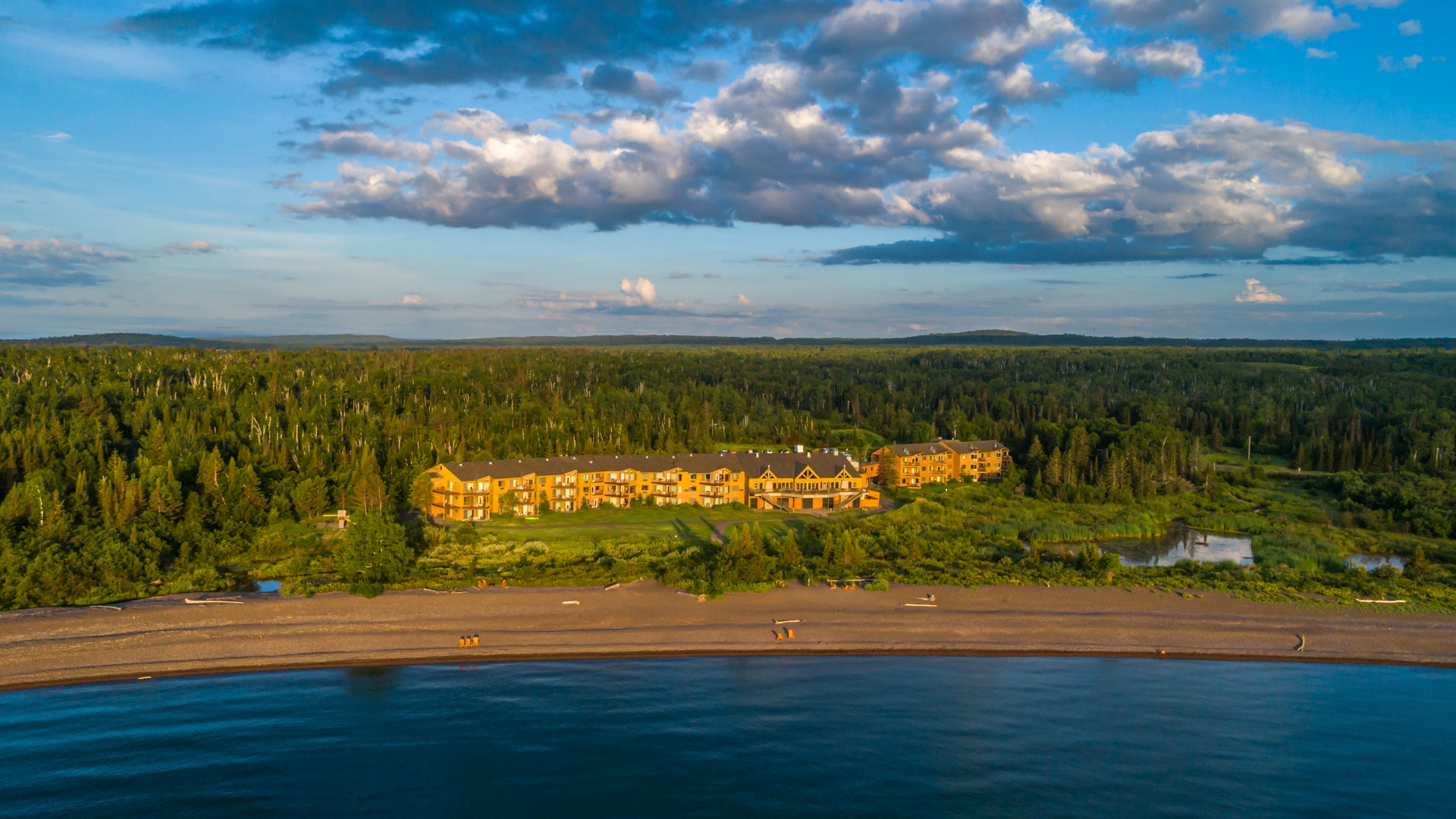 View of the superior shores property surrounded by the ocean and trees 