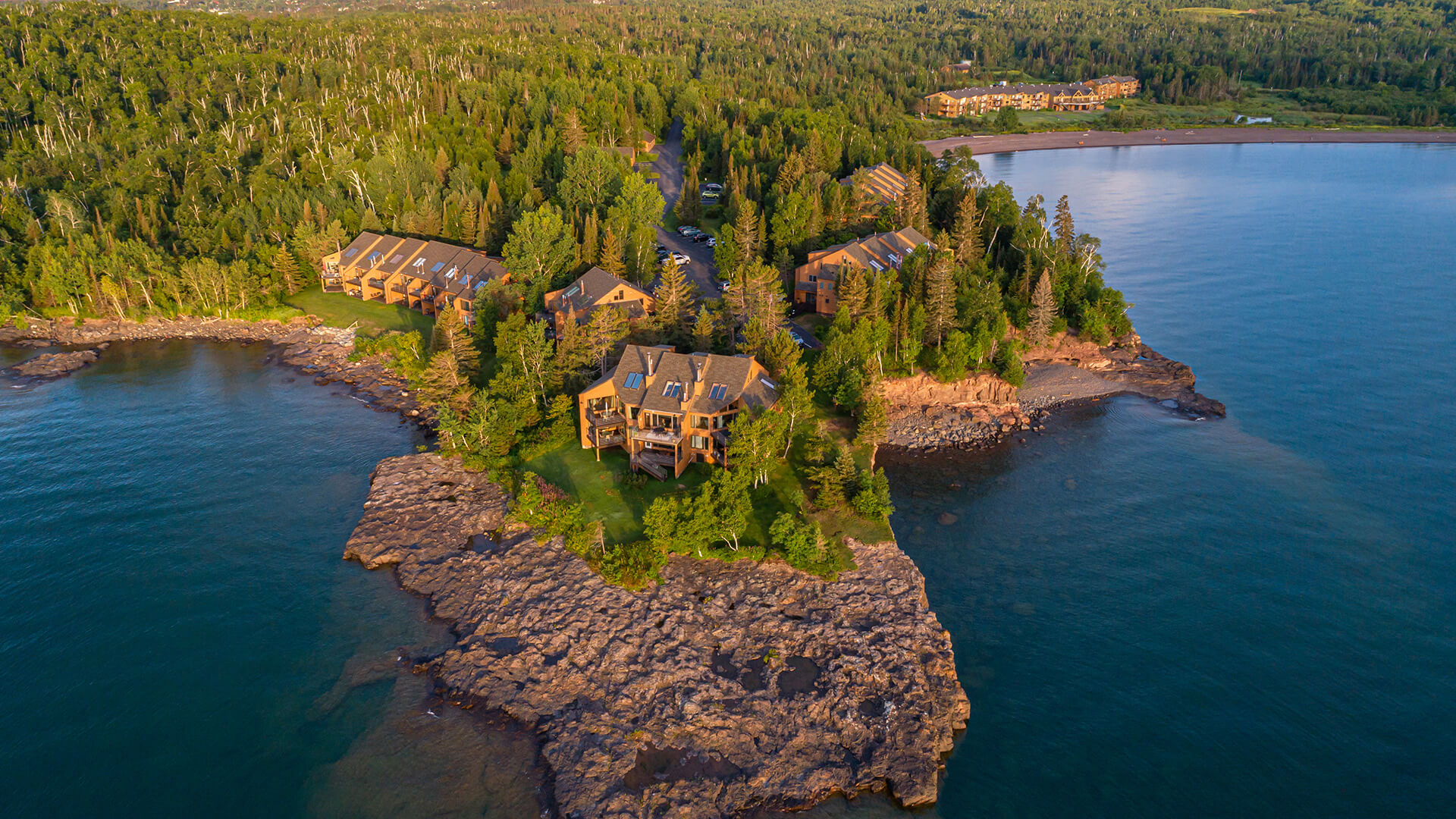 View of the superior shores property surrounded by the ocean and trees 
