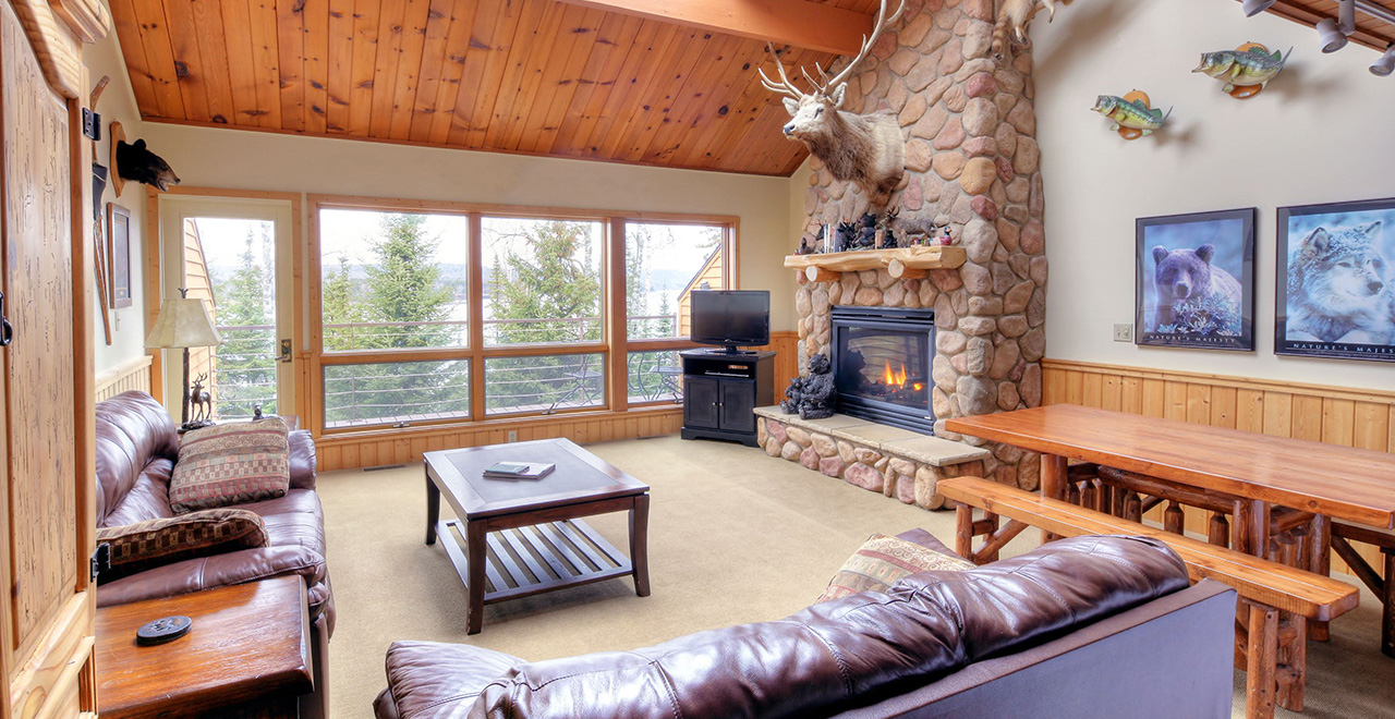 living room with fireplace decorated with wildlife decor