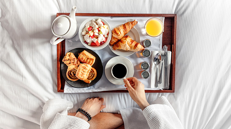overhead view of a fancy breakfast in bed
