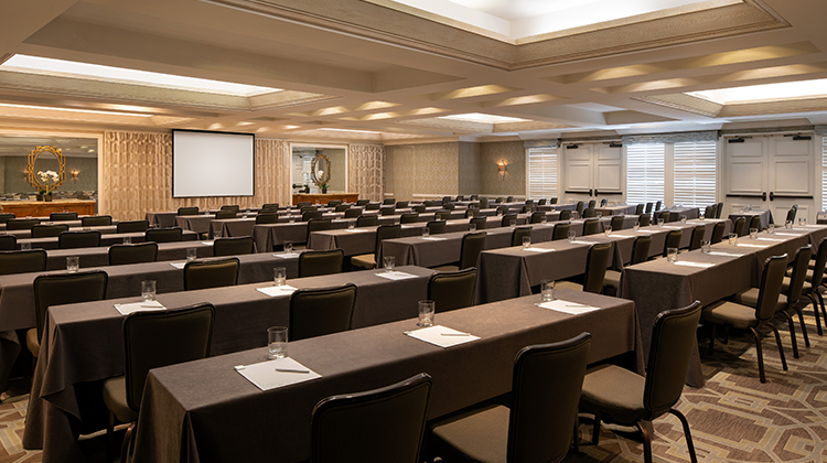 large conference room filled with black tables and chairs