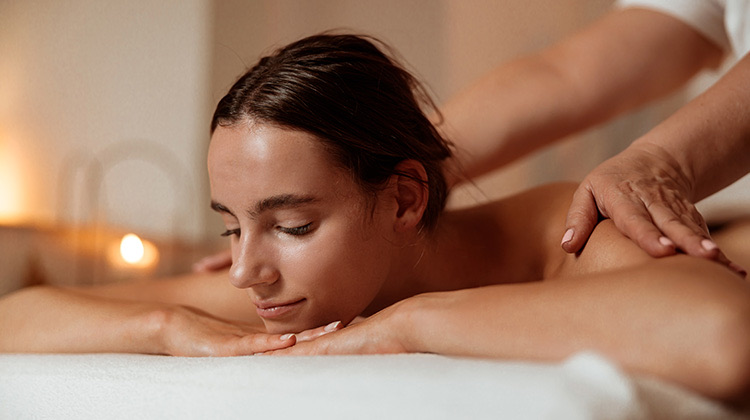 woman getting a massage at the resort spa