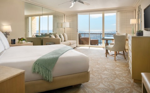 elegant bedroom with a view of the ocean