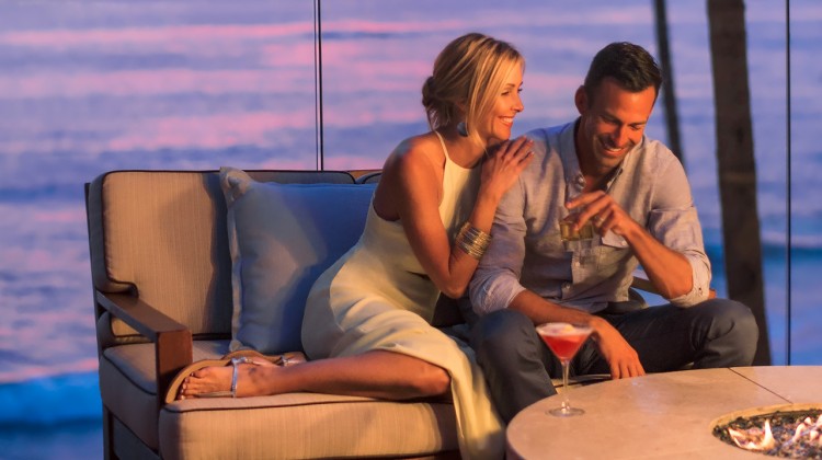 couple lounging on an outdoor couch