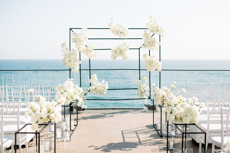 wedding ceremony setup with backdrop view of the ocean