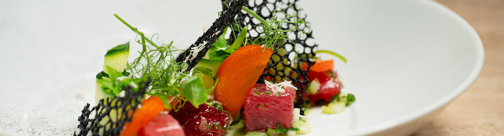 an elegant dish with fresh tuna and vegetables