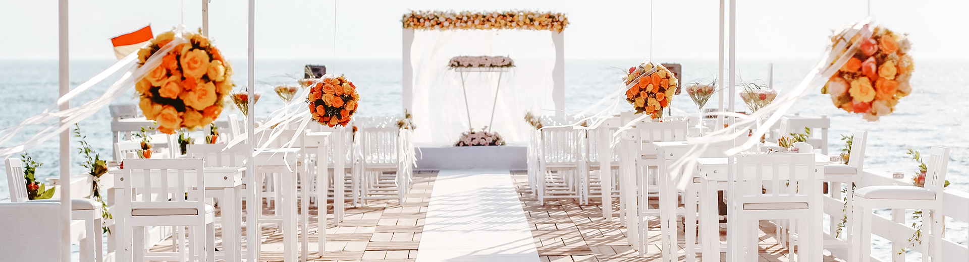 view of an elegant wedding isle with orange flowers