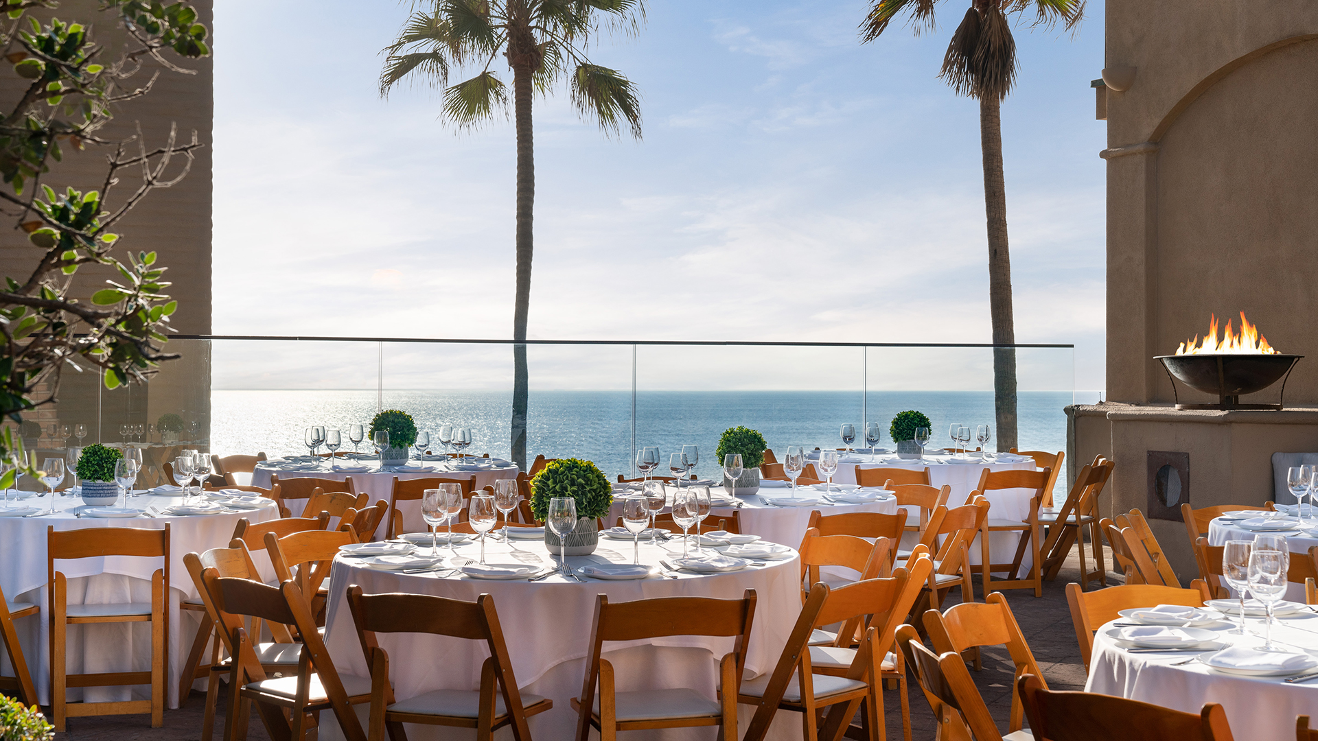 outdoor venue with several tables and a fire-pit