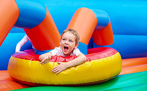child playing in bouncy house