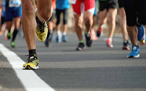 close up image of peoples shoes while running