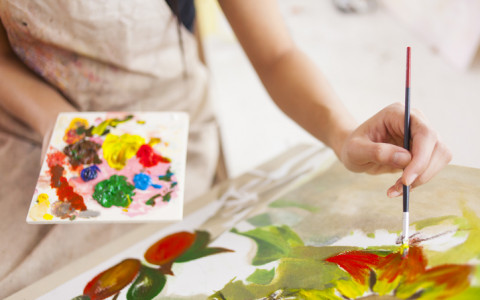 woman painting on canvas