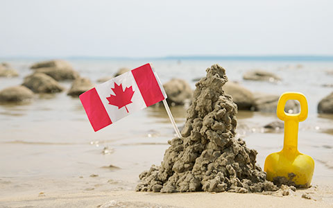 Canadian flag mounted in sand