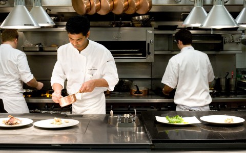 chefs working on the dishes within the kitchen