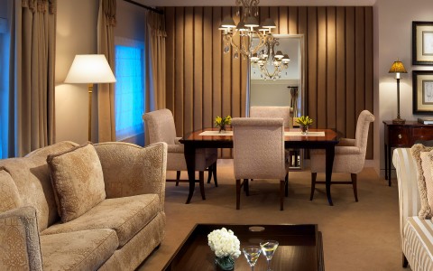 luxury suite with modern furniture and a dining table