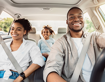 family in the car beginning their road trip drive