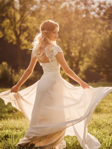 bride spinning around in a field