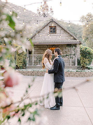 bride and groom dancing outside Stone House