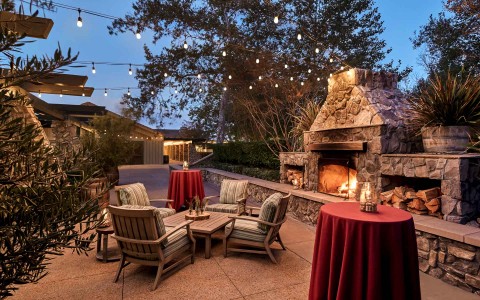 outside lounge and dining space near a fire pit