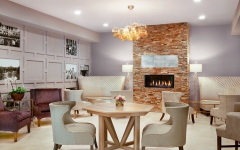 sitting area with tables, chairs, and a fireplace