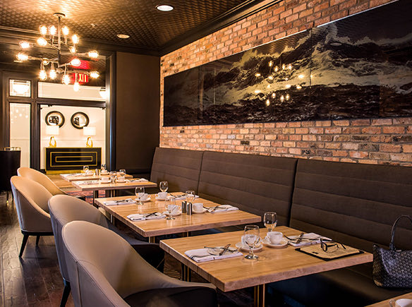 interior of launch dining area with brown accent colors and a brick wall