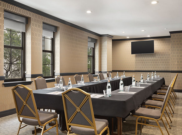 alabama meeting room with gold chairs and a long u-shaped table