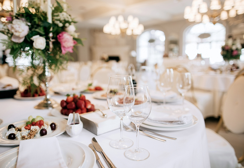indoor venue with a close up image of place settings for a wedding