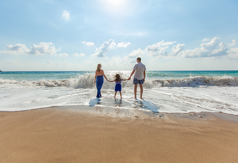 a family standing in the ocean water