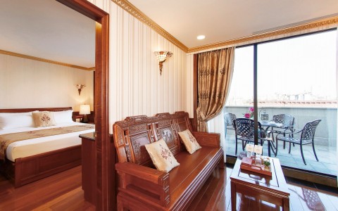 suite bedroom and living room with wooden bench and outdoor patio