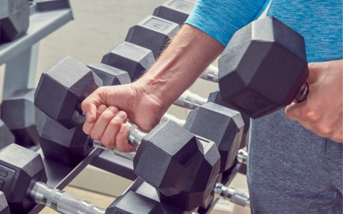 man picking up weights