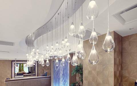 hotel lobby decorated with hanging light fixture