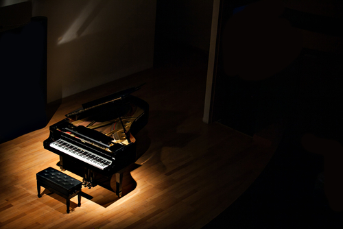 spotlight on a grand piano