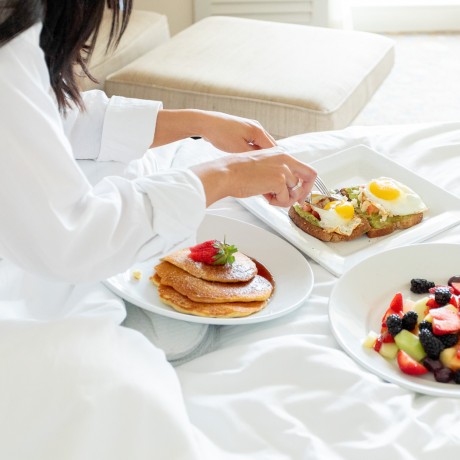 cutting up breakfast in bed