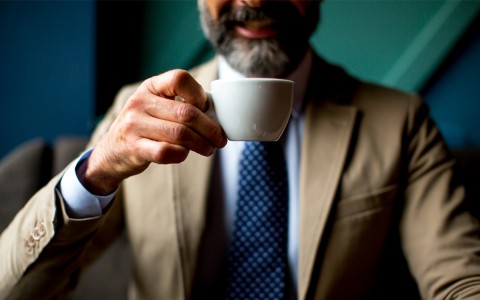 man holding coffee cup