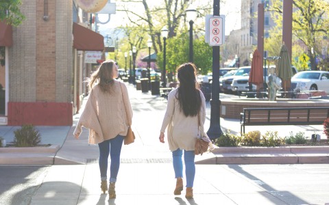 women walking on sidewalk 
