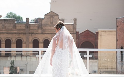 a bride wearing her dress outside as the sun is shining