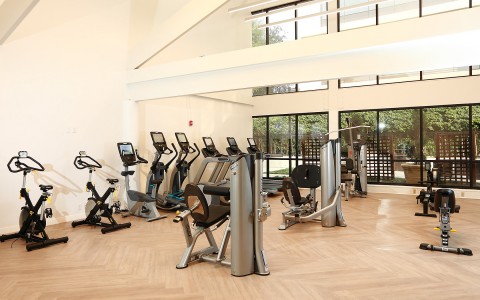 hotel fitness center with eliptical machines and weight benches