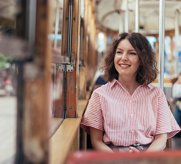 woman sitting on a trolley looking out the window