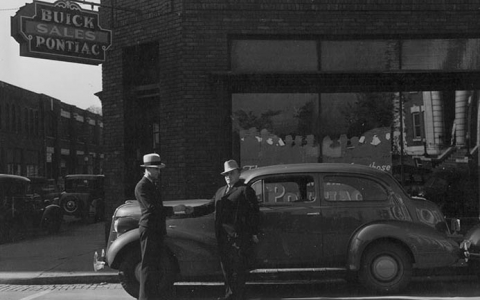 old photograph of two men and a car