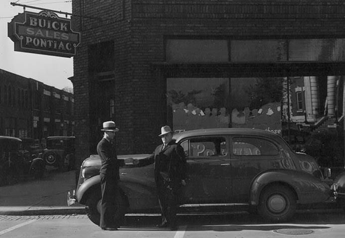 old photograph of two men and a car