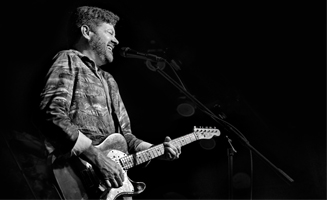 male playing guitar and singing