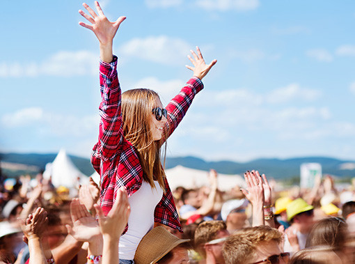 girl with her hands in the air at a concert