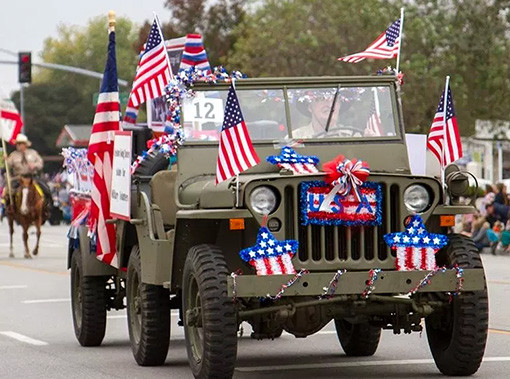 army colored jeep covered in american flags