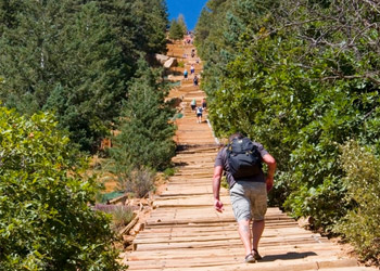 View of Pike's Peak Manitou Incline trail, a line of people are hiking up the path