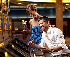 a couple enjoying cocktails and playing a casino game