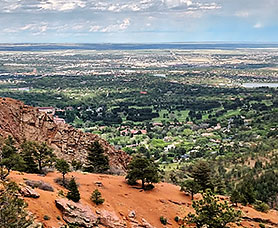 view of the green North Cheyenne Canon Park from the top of a mountain