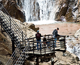 group of people looking at the seven falls from stairs 