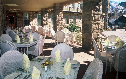 outside dining area, white wicker chairs and tables 