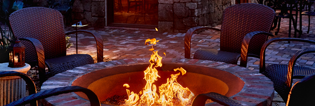 fire pit with chairs around it