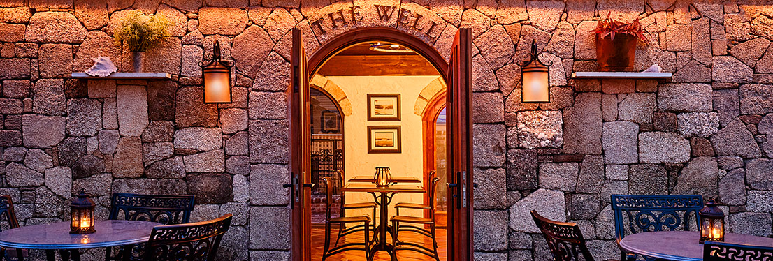 Stone exterior of "The Well" bar looking into the bar