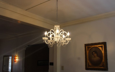 light fixture with a photo frame hanging on the wall behind it